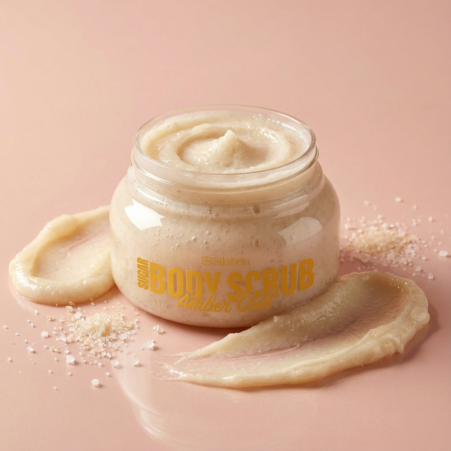 Jar of body scrub with visible brand name on a pink background
