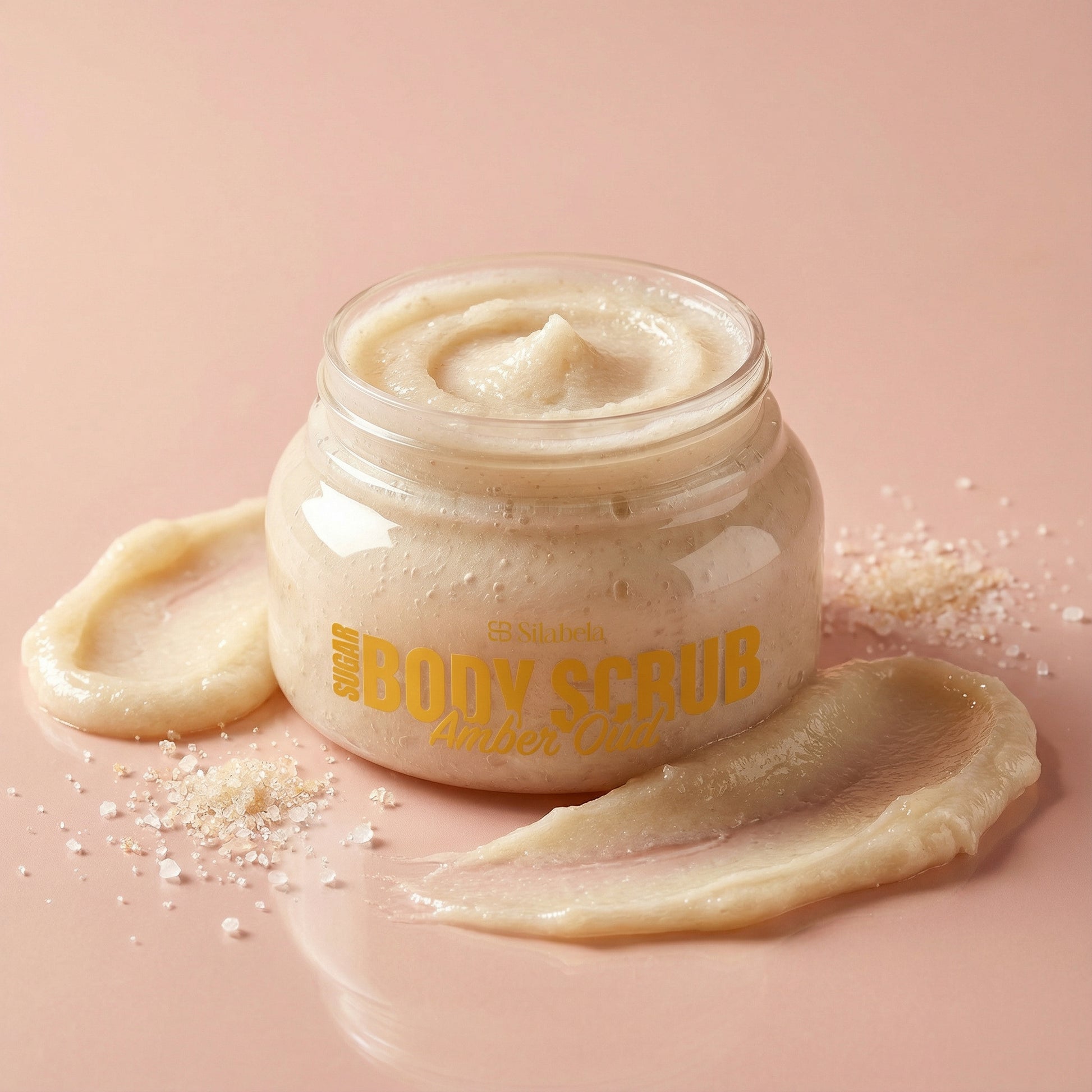 Jar of body scrub with visible brand name on a pink background